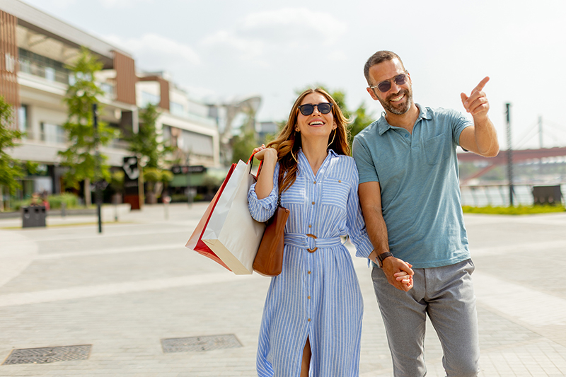 Joyful couple enjoying a sunny day of shopping and exploration together